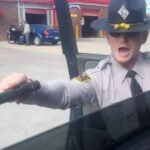 Angry cop pulls gun on teen