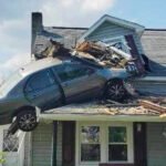 A car crashed into a house's second floor.