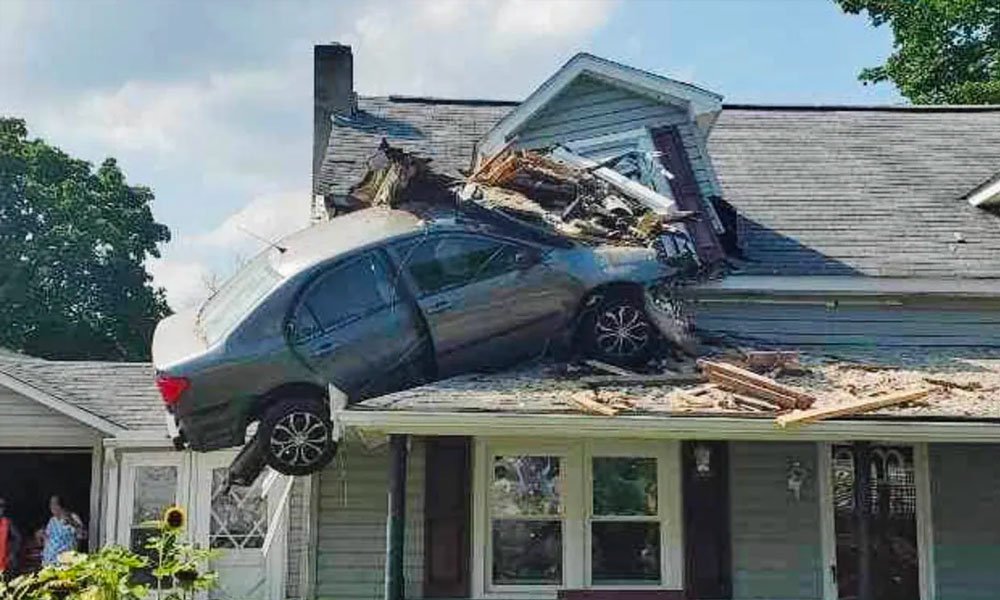 A car crashed into a house's second floor.