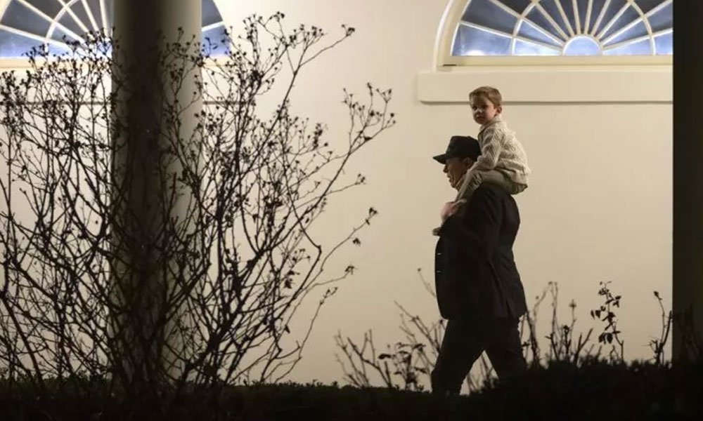 Elon Musk carries his son X Æ A-Xii as he walks across the Colonnade of the White House after arriving with President Donald Trump on Marine One, on Sunday, March 2, 2025, in Washington D.C.