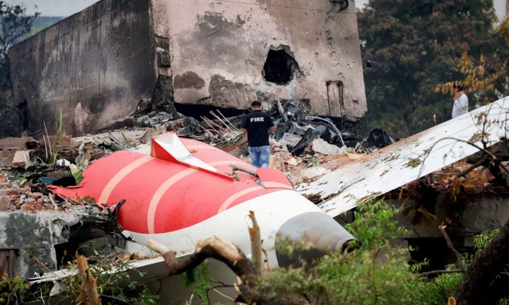 Wreckage of the Air India Boeing 787-8 Dreamliner plane sits on the open ground, outside Sardar Vallabhbhai Patel International Airport.