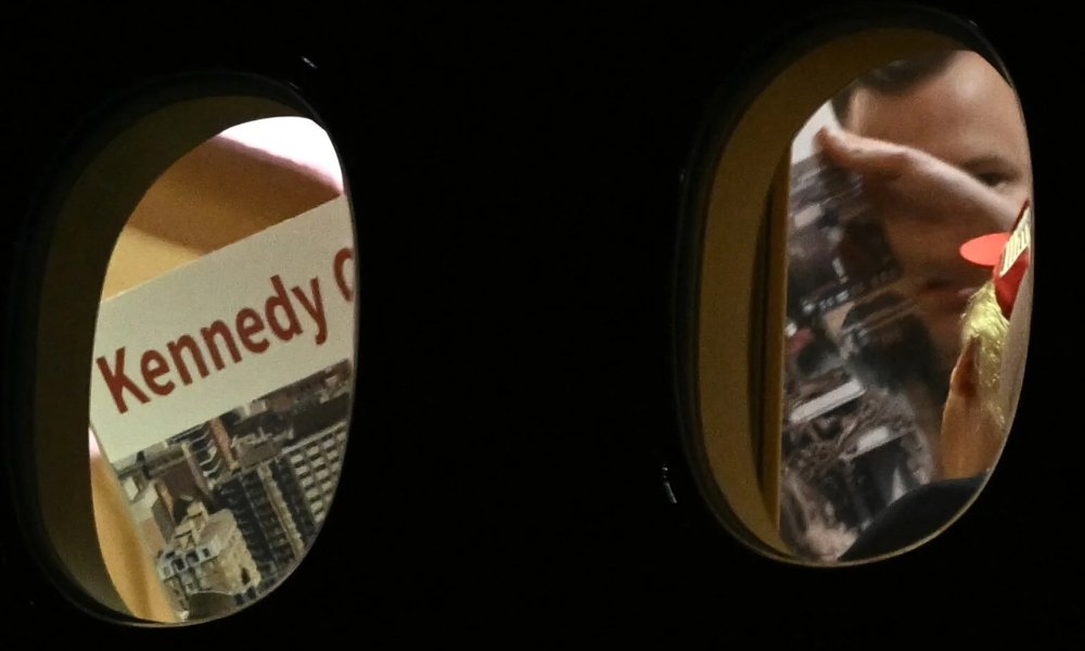 The poster board appears related to the Kennedy Center, though much of it is not visible in the images.