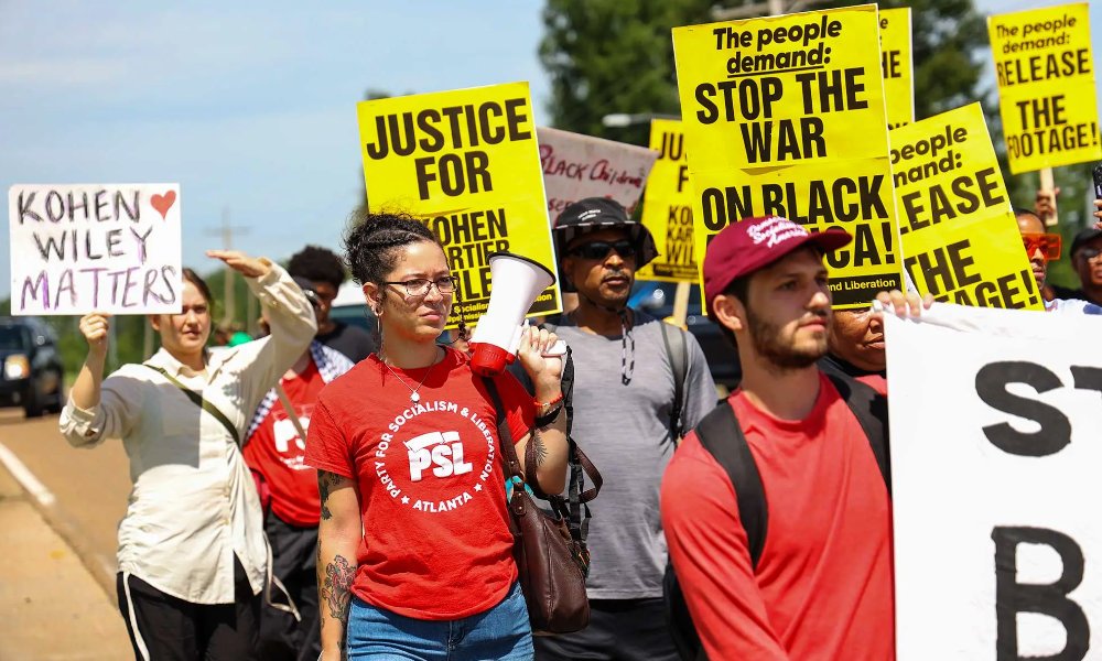 Demonstrators of different racial backgrounds take to the streets of Senatobia, Miss., on June 26, 2026, demanding accountability for the police killing of 1-year-old Kohen Wiley.